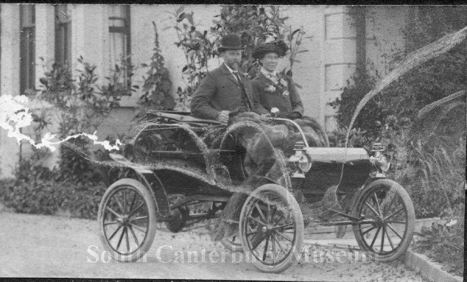 1358 Mr and Mrs Francis Brown sitting in a 1901 Oldsmobile motor car South Canterbury Museum