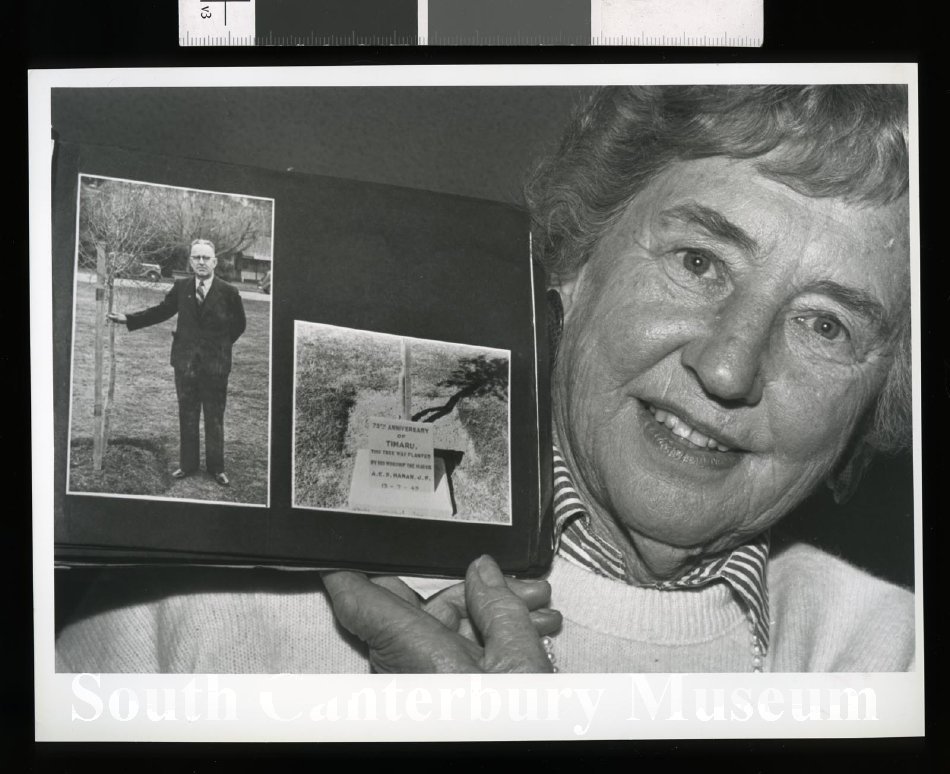 20121862887 Joan Evans 1992 holding photographs of Mayor Hanan 75th Anniversary