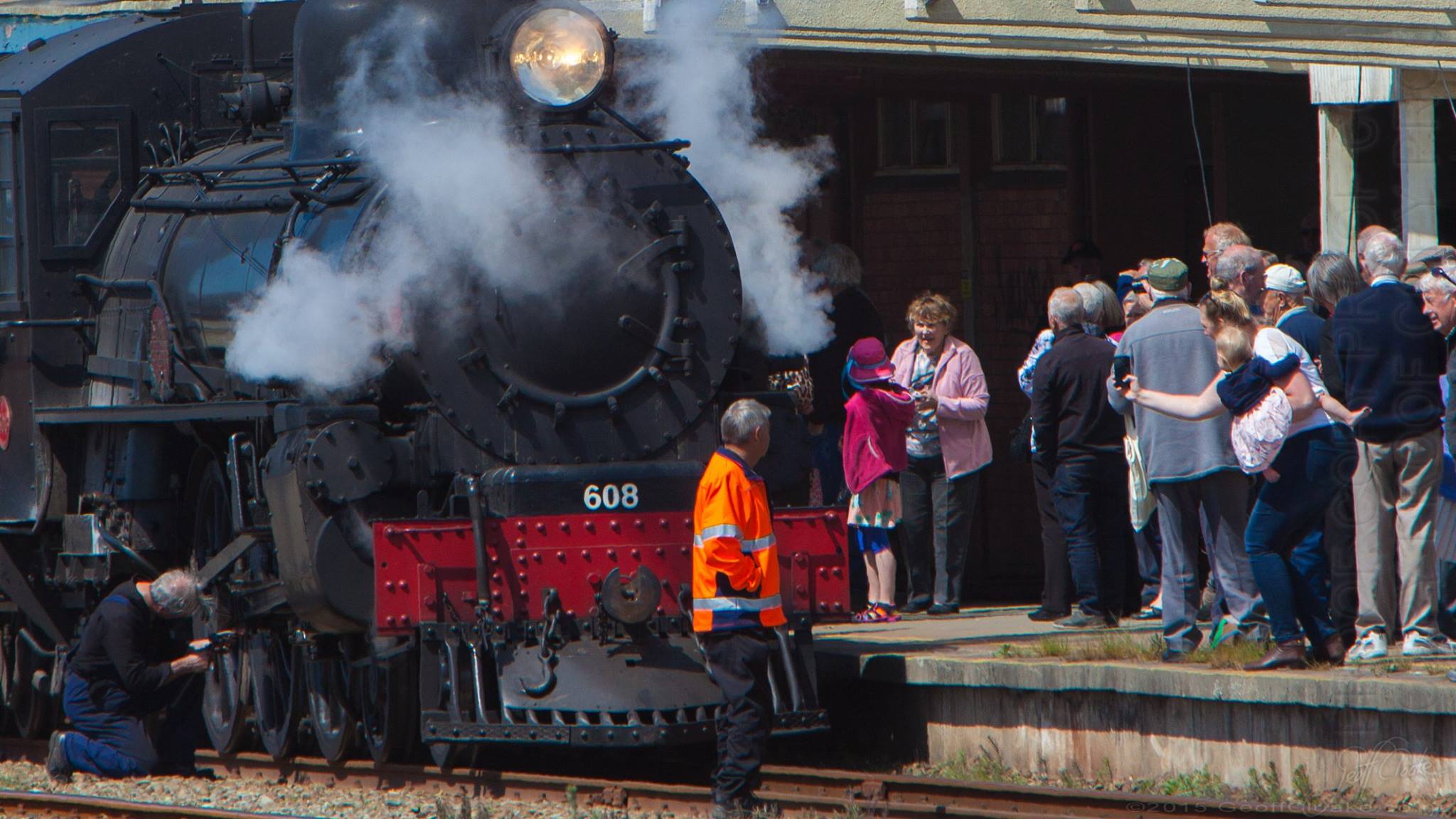 Roselyn Fauth with daughter Annabelle on her hip catching a photo of a special train visit at the Timaru Railway Station Photo By Geoff Cloake