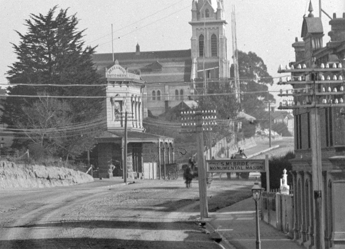 Section of a photo of Post Office Timaru circa 1904 by Muir Moodie Te Papa 014403 shows Zealandia Butchers and McBride Masons
